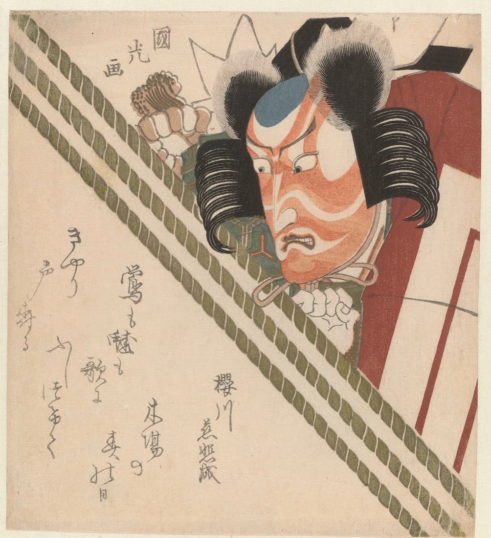 『暫』の鎌倉権五郎に扮した七代目市川團十郎。紅の筋隈を描いた顔で目を見開き、力紙を結った鬘で竹垣の向こうから身を乗り出す大首の摺物